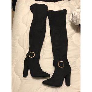 Knee high black heeled boots